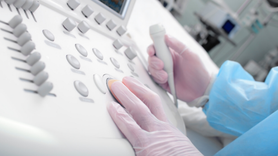 Clinician using handheld ultrasound transducer - EDM Medical Solutions