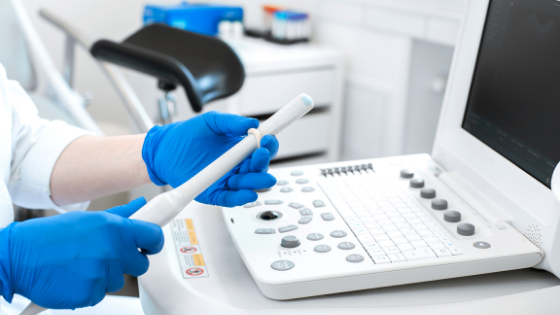 Practitioner applies ultrasound probe cover to transducer for endocavity procedure